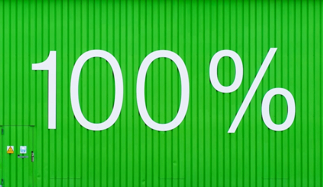 The figure 100% painted in white on a green corrugated metal wall