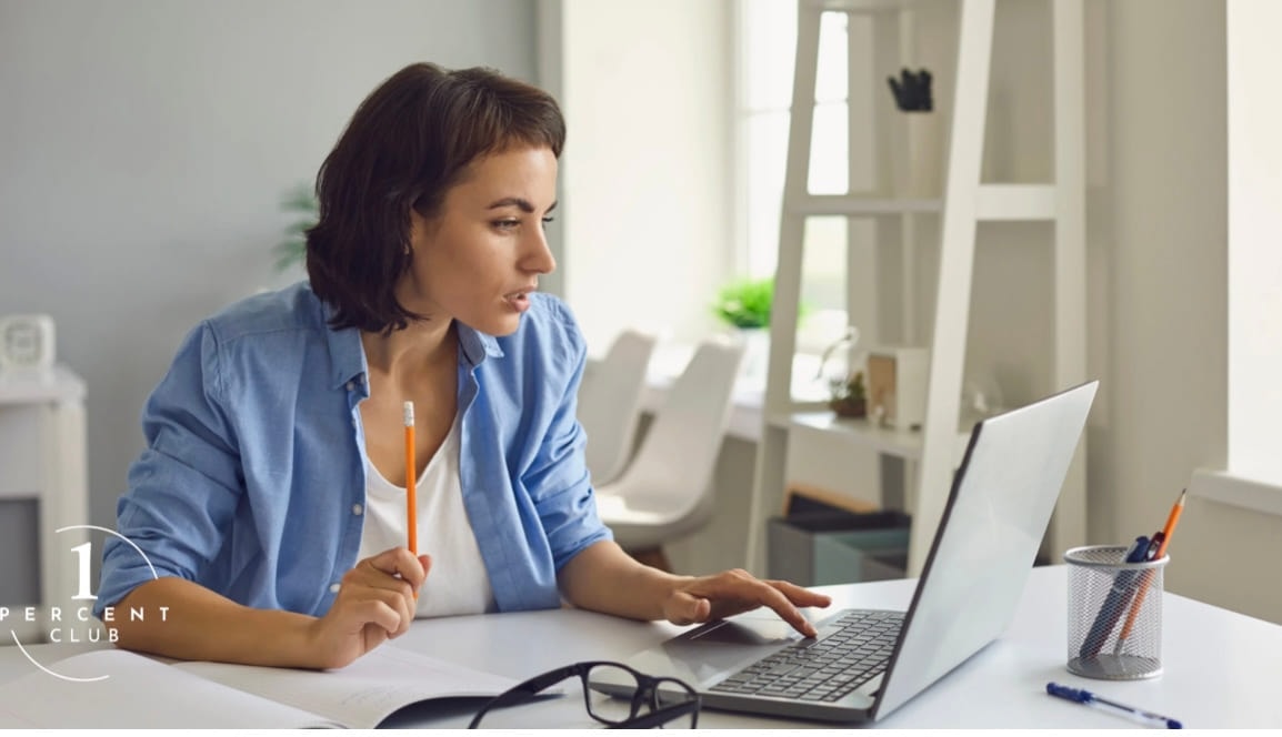 A woman working at a laptop in a bright office