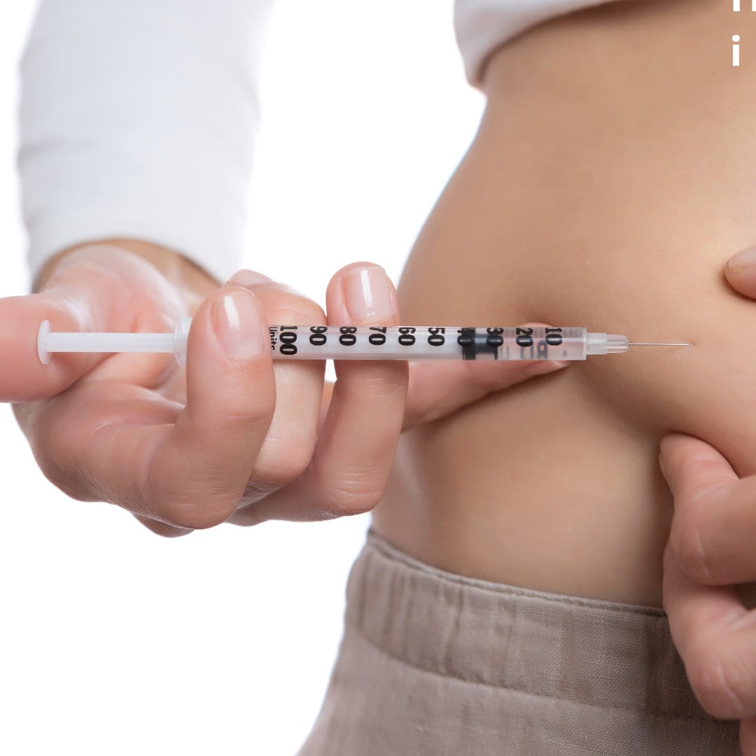 A person injecting into the skin of their abdomen with a fine syringe