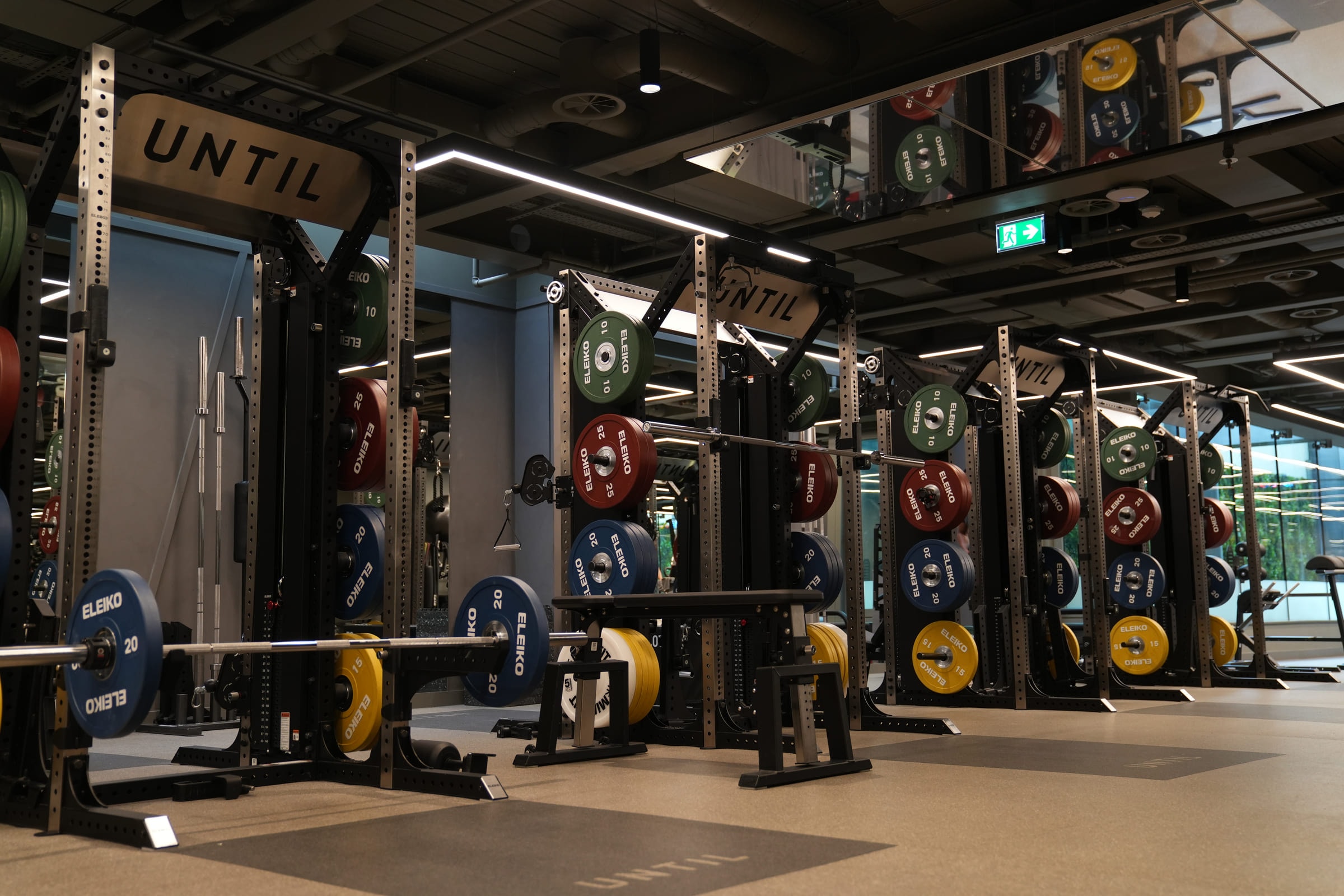 Racks and loaded barbells on the training floor at UNTIL, Orchard Street